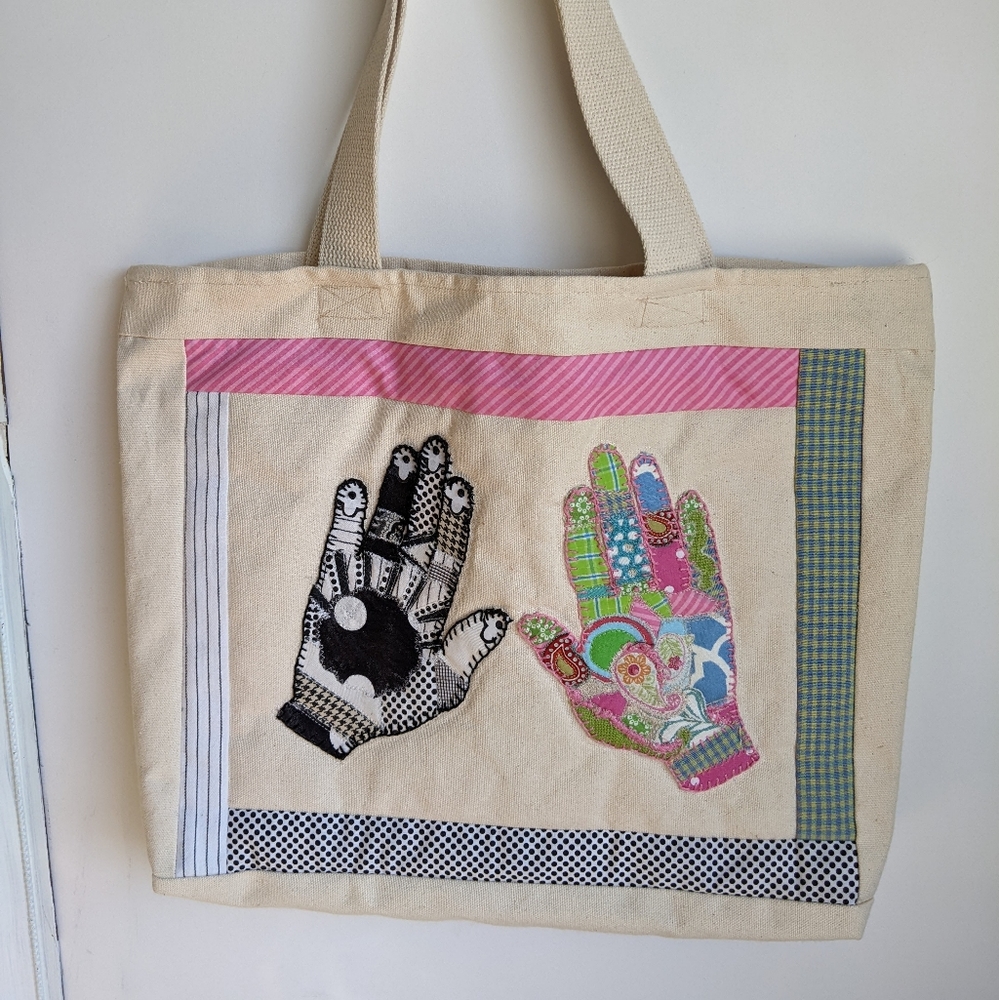 Canvas tote with embroidered applique hands